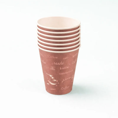 Stack of pink paper cups with coffee-themed text on a white background